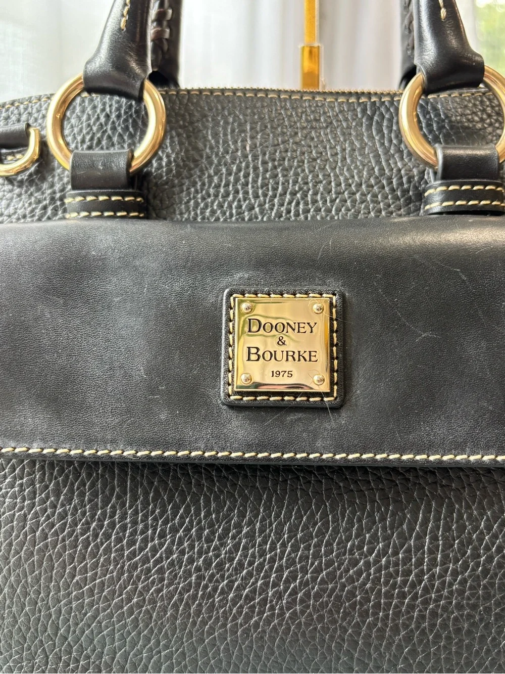 Dooney & Bourke Black Leather Satchel with Gold Hardware and Tassel
